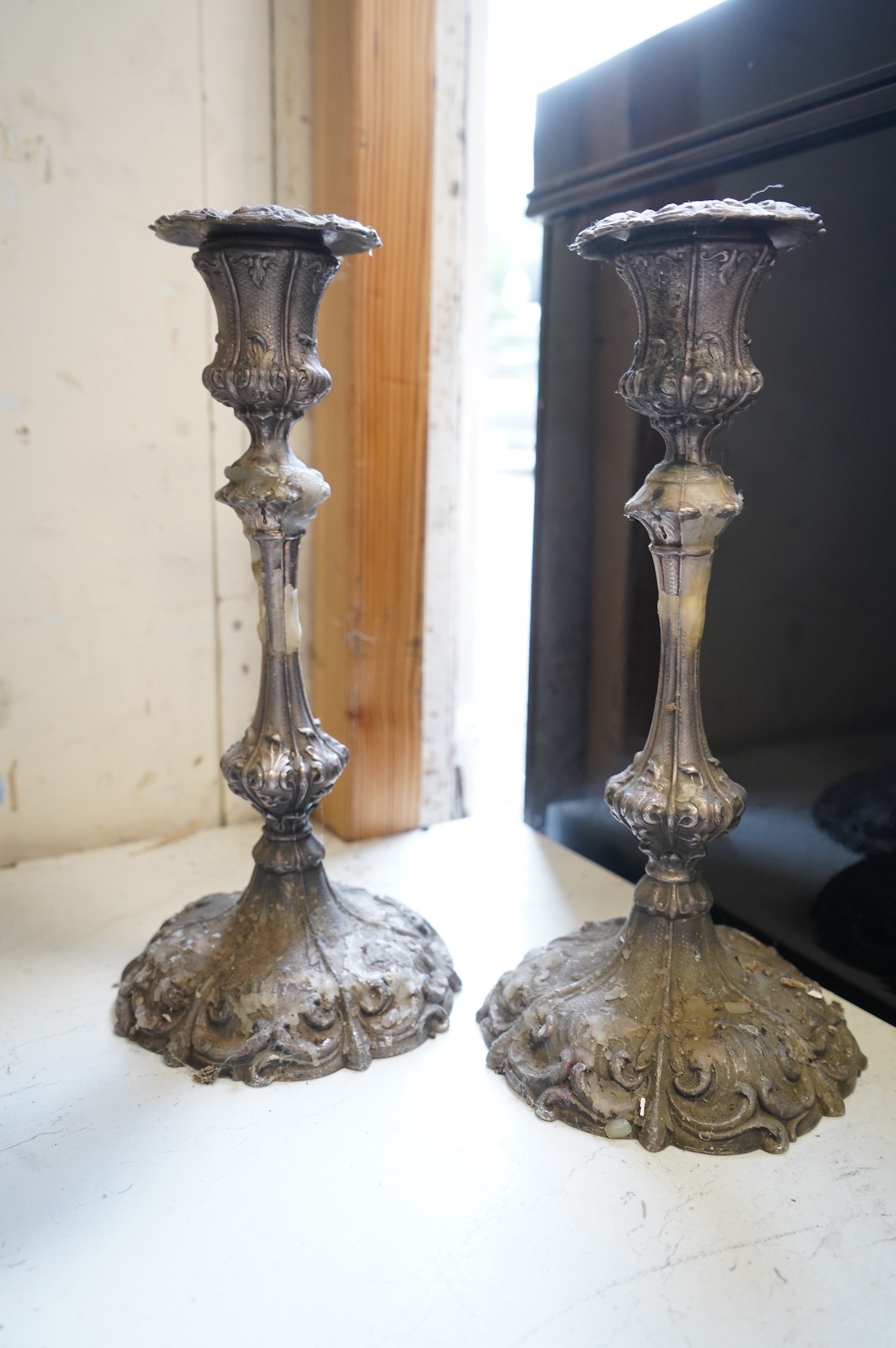 A pair of silver plated candlesticks, a four branch, three light candlestick and a copper cauldron